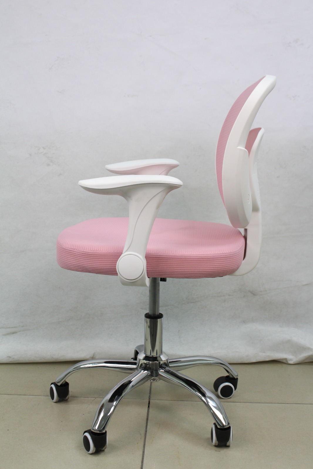 Pink Mesh Study Chair with Flip-Up Arms, side view