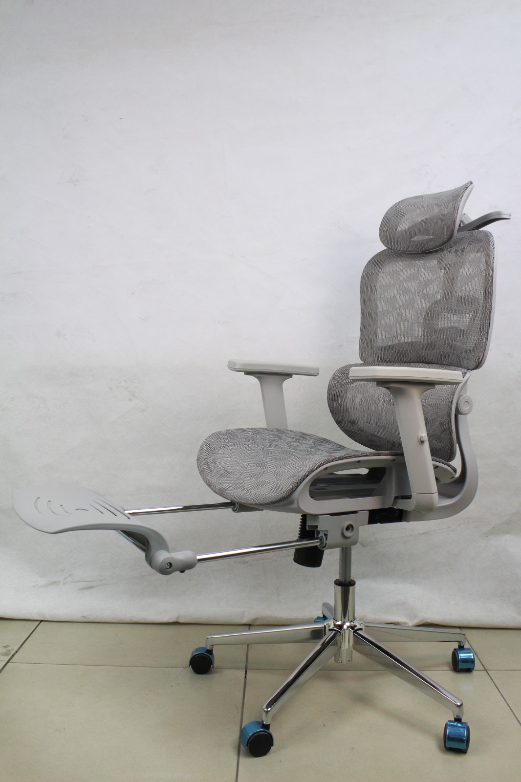 Grey Full Mesh Ergonomic Chair with Headrest and Footrest, side angle with the footrest pulled out